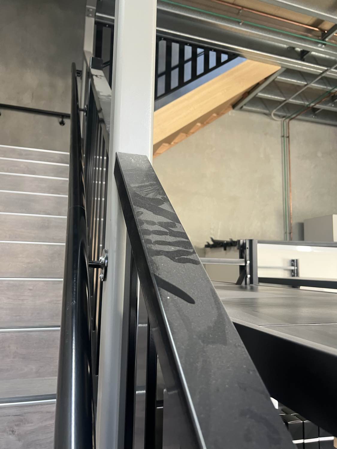 A dusty mezzanine handrail before cleaning